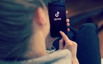 woman looking at tiktok on her phone